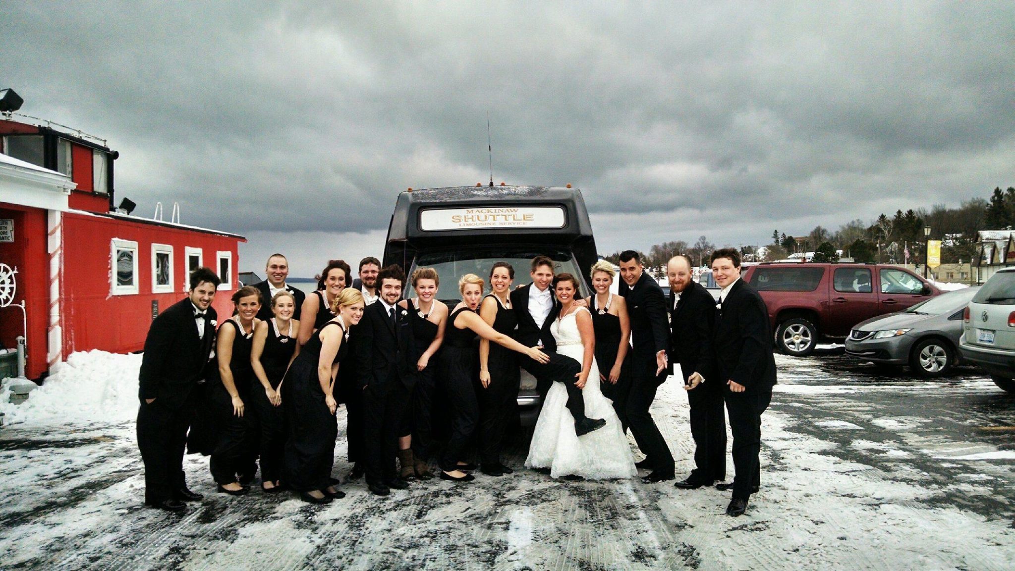 Wedding couple at the door of a Mackinaw Shuttle vehicle
